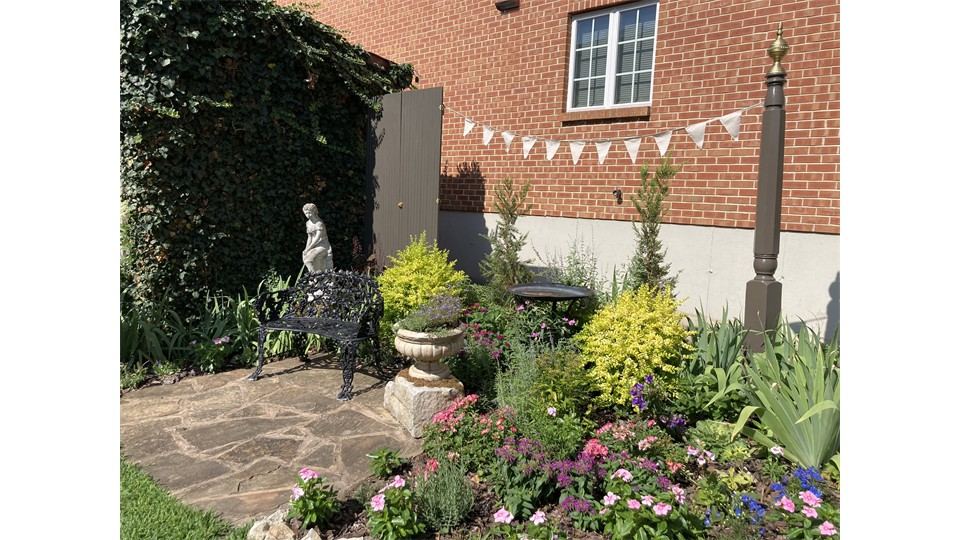 European inspired courtyard garden with bench and statue
