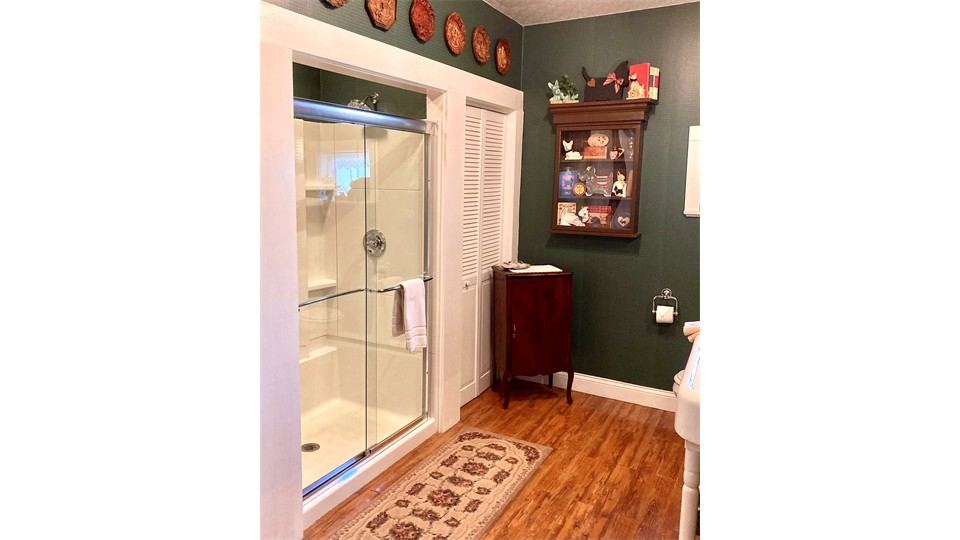 Bathing room with plaid walls and glass shower
