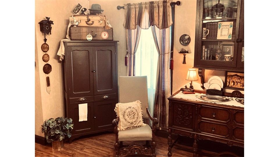 Antique cabinet corner with travel trunk and clock