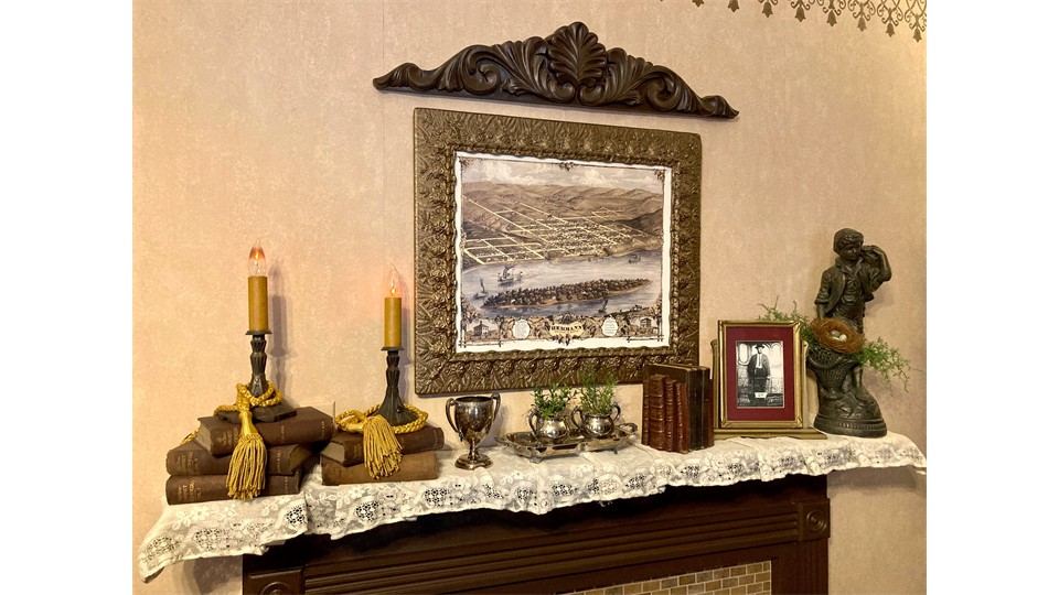 Mantel with historic Hermann print, candles and books